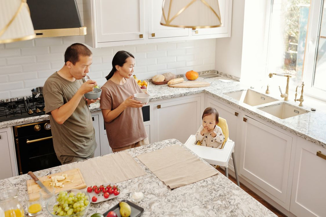 Family in a bright kitchen preparing drinks