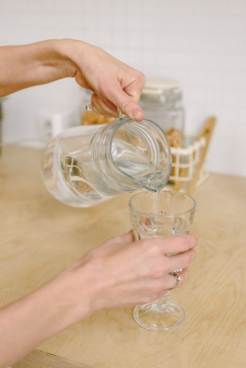 Fresh water being poured into a clear glass