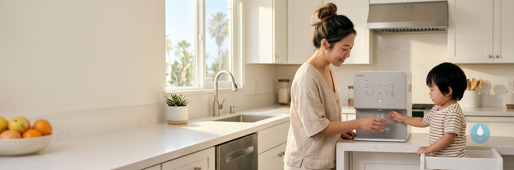 Korean mother and toddler dispensing water from Coway purifier in bright Los Angeles kitchen